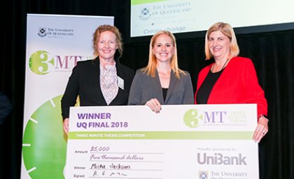 2018 UQ 3MT Winner Micha Jackson (centre), with Glinda Major from UniBank (left) and Professor Bronwyn Harch, UQ Deputy Vice-Chancellor (Research) winner-micha-jackson-holding-a-big-dummy-cheque-flanked-by-competition-officials